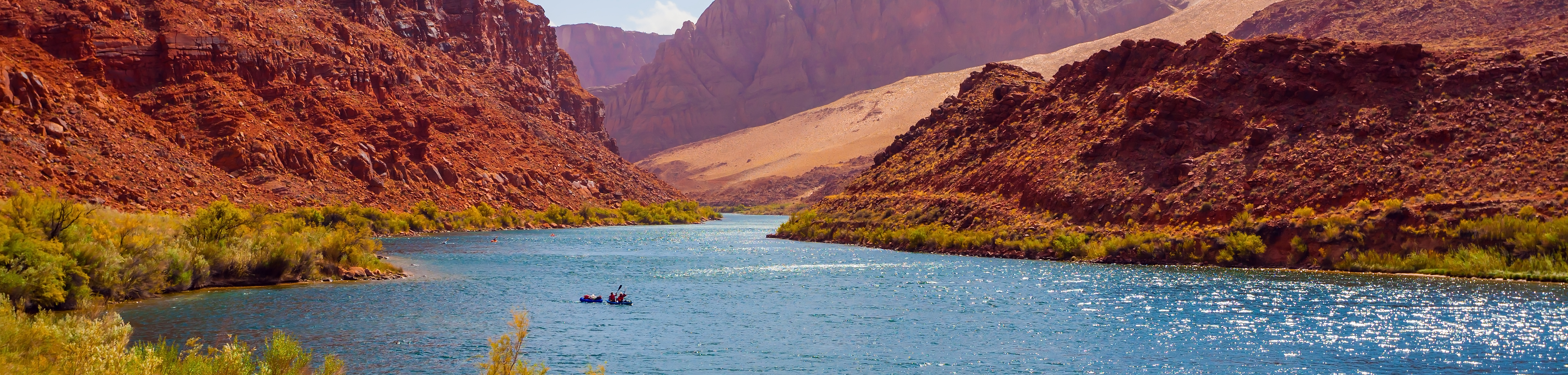 river surrounded by red rock desert