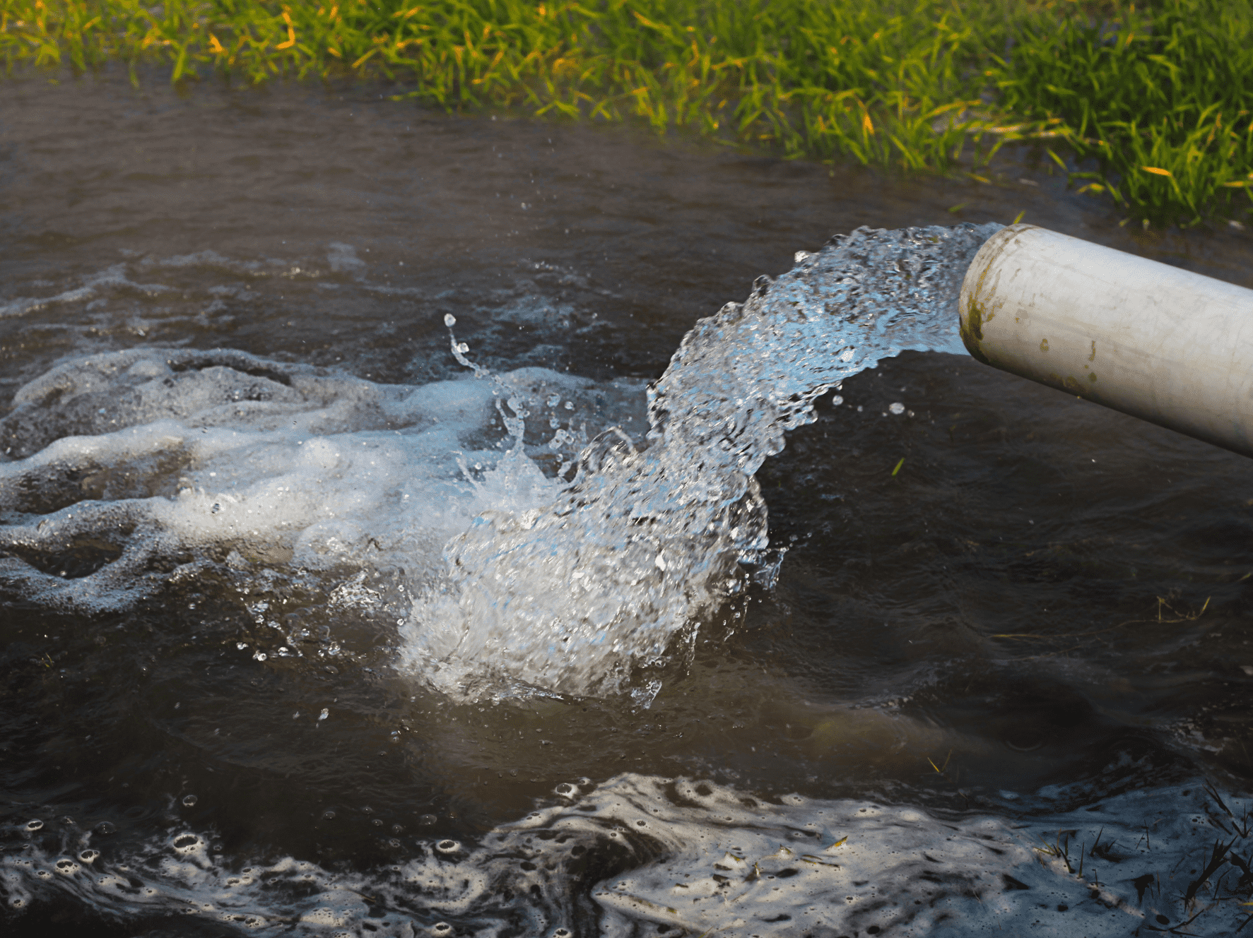 water flowing out of an irrigation pipe
